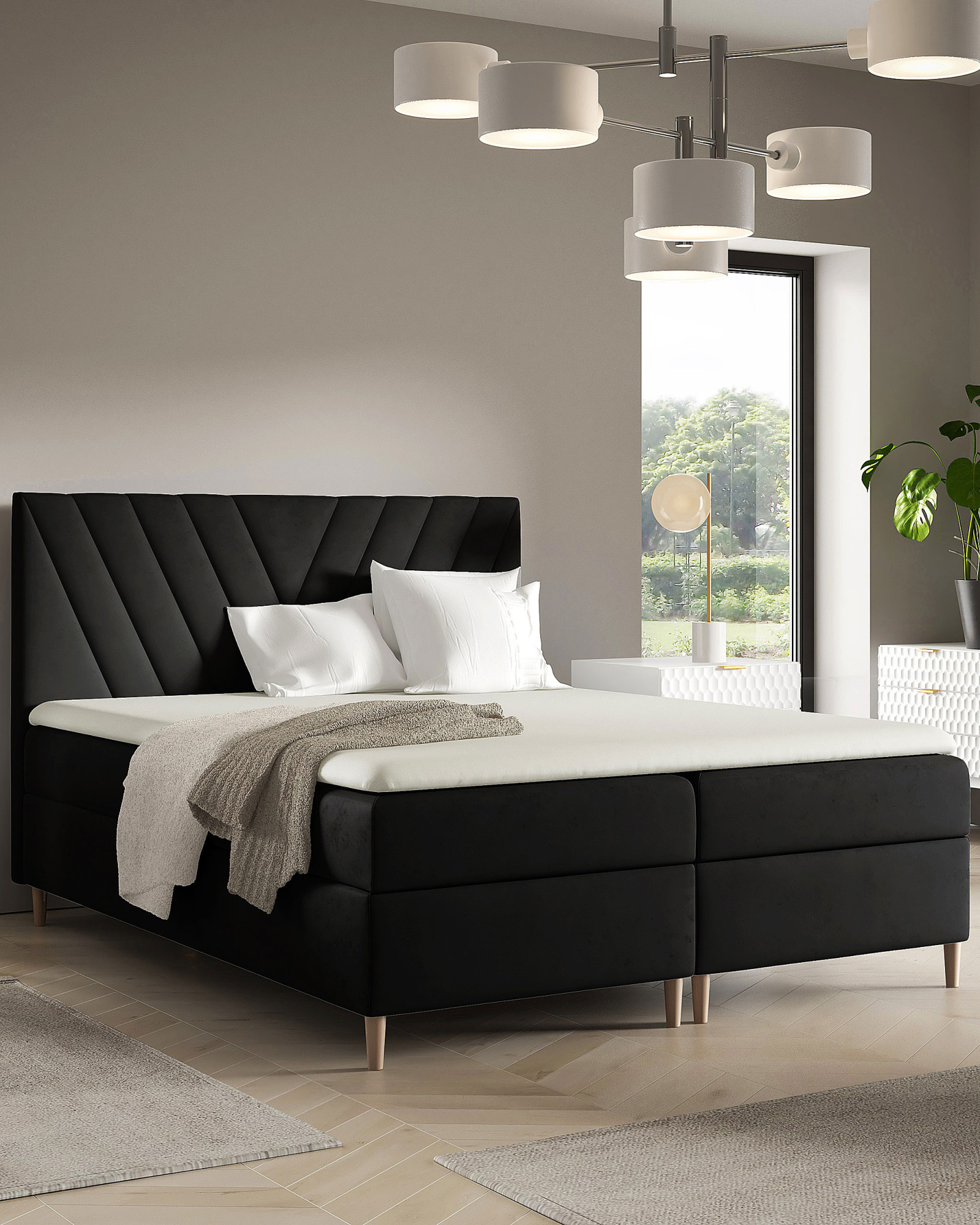 Aranżacja wnętrza z czarnym łóżkiem 