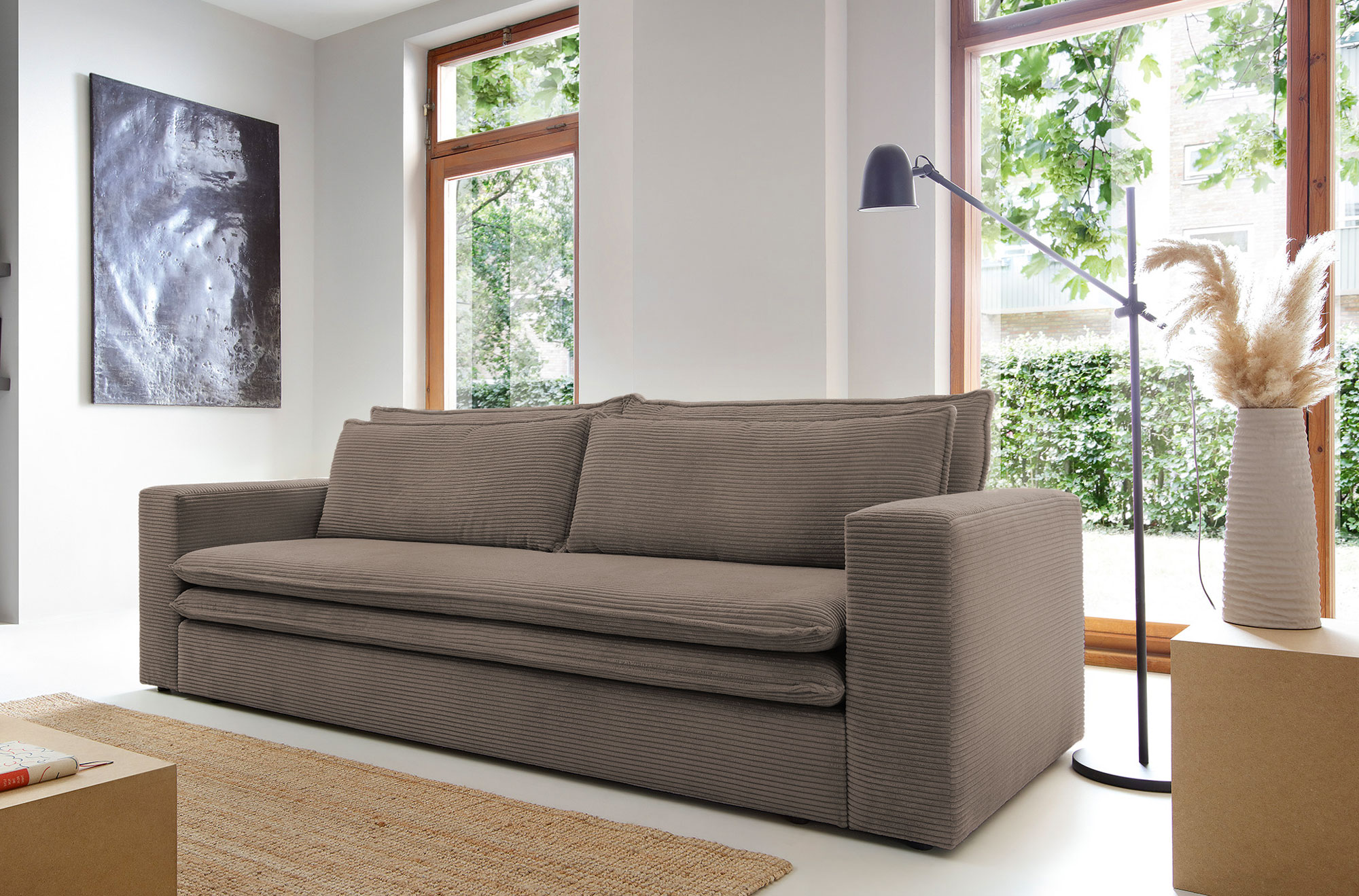 Wnętrze z brązową sofa z funkcją spania Eriena 3X