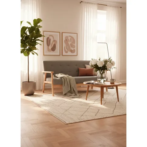 Jasnoszara sofa z pikowanym oparciem   Sybis